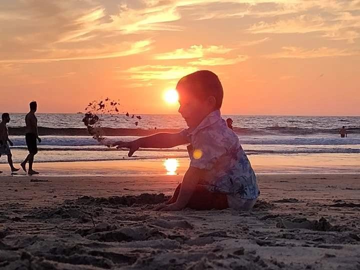 Child on beach at sunset