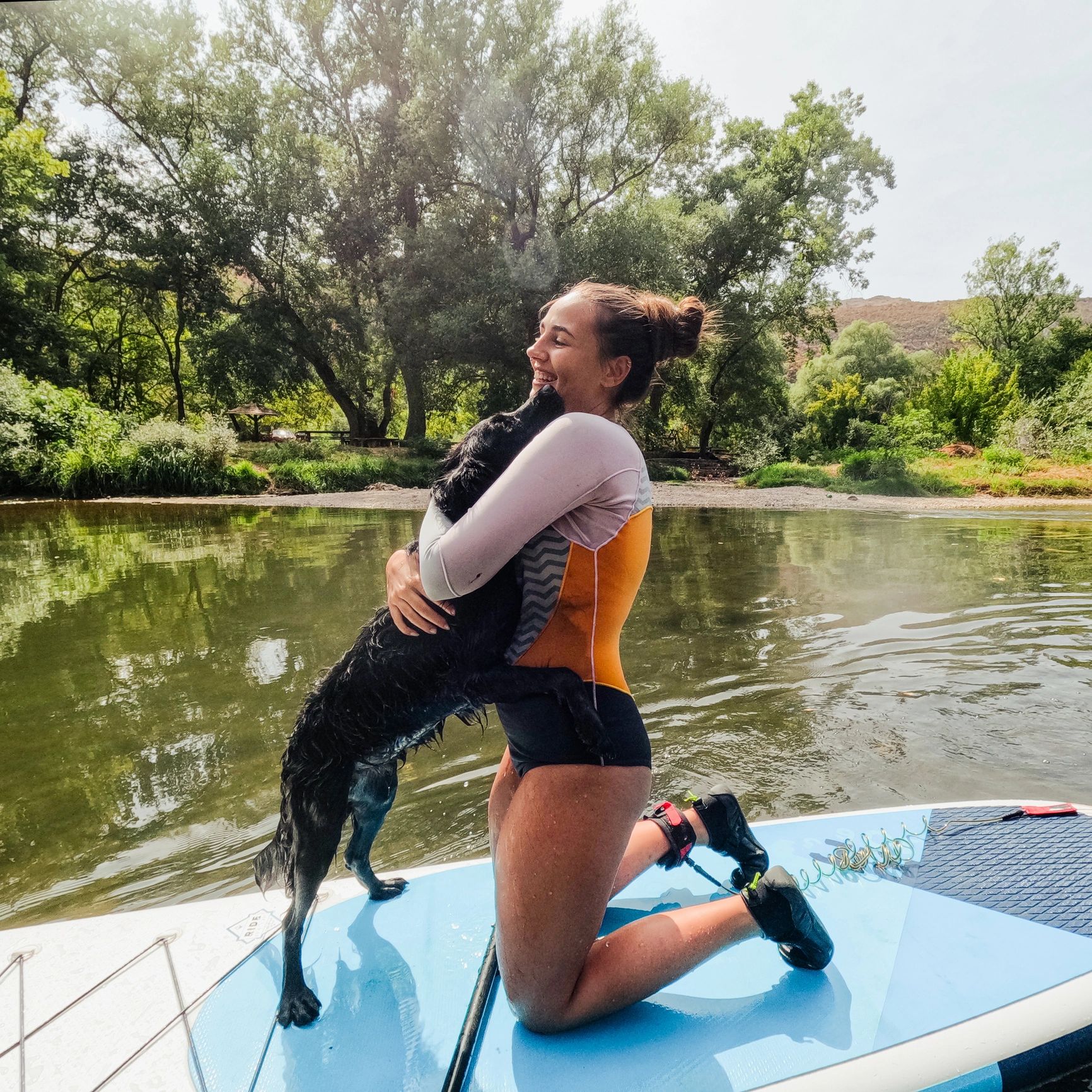 Woman on paddleboard with dog