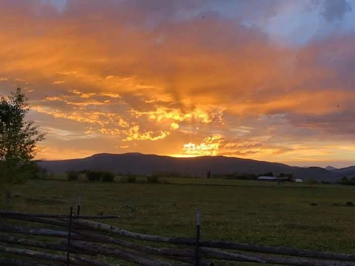 Rural sunset over farm landscape